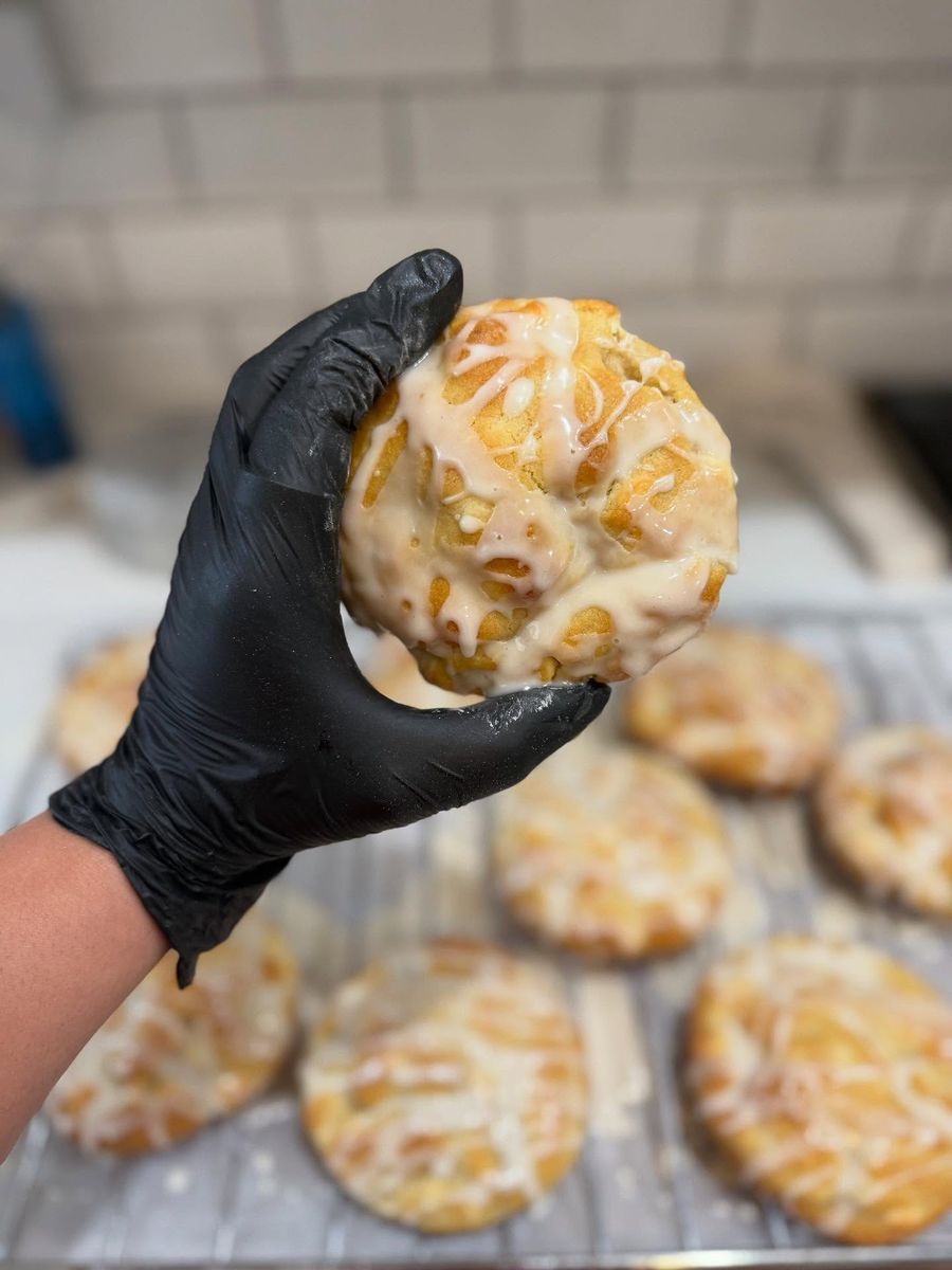 A glazed Lauren's Lemon White Chocolate Chip cookie